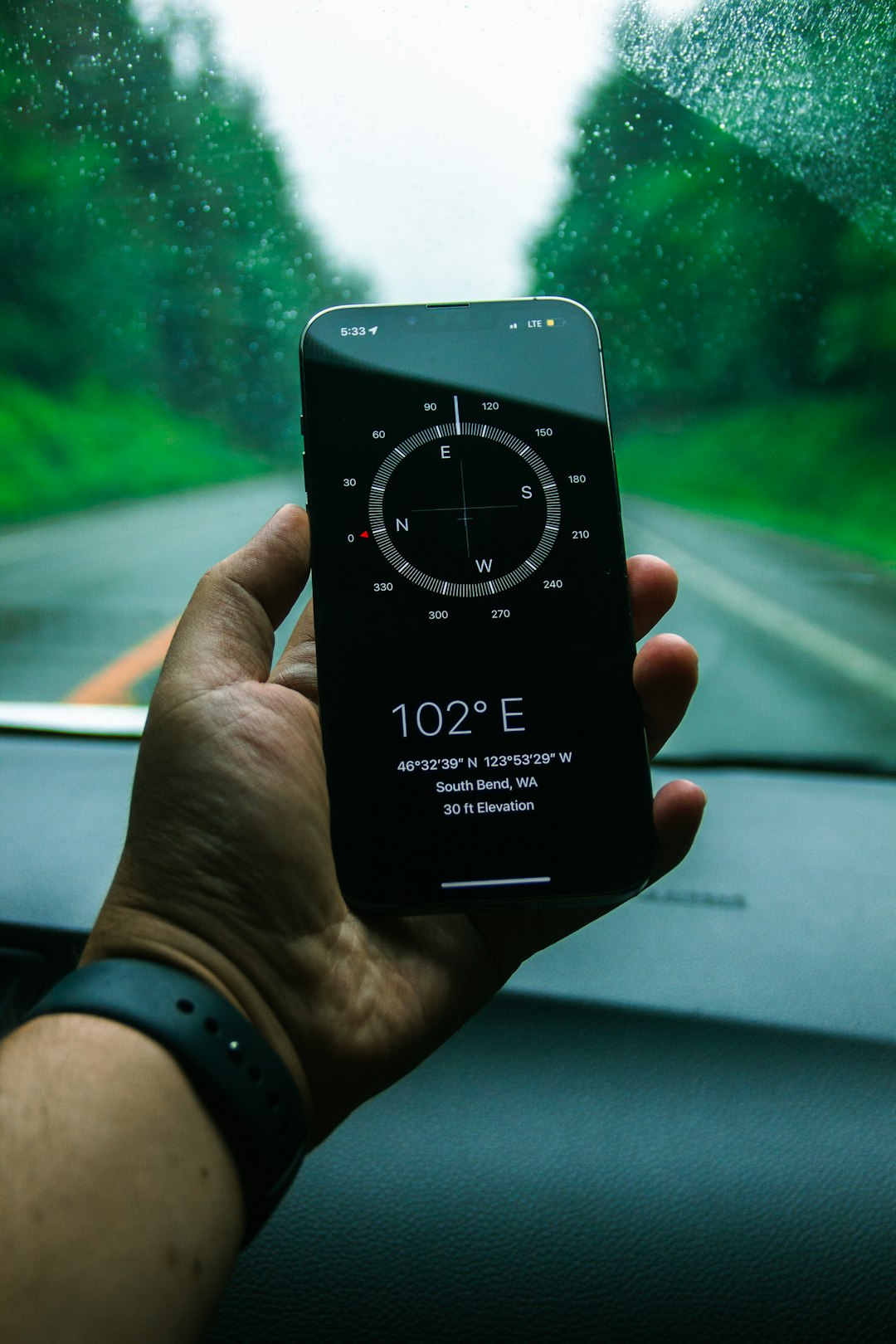 hand-holding-smartphone-displaying-compass-and-coordinates-2nxmpqtxq64